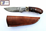 Fixed-blade hunting knife with patterned Damascus steel blade and polished walnut handle featuring a stag horn bolster, displayed next to a brown leather sheath with white stitching.