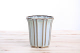 4.5-inch ceramic cascade bonsai pot with vertical ridges and glazed in soft glacier blue and brown accents, shown on a light wooden surface.