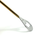 Long bar spoon with a twisted gold handle and a silver bottle opener end featuring a heart-shaped cutout, shown against a white background.