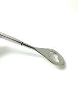 Silver bartending spoon with a heart-shaped cutout at the rounded end, shown on a white background with a polished reflective surface.