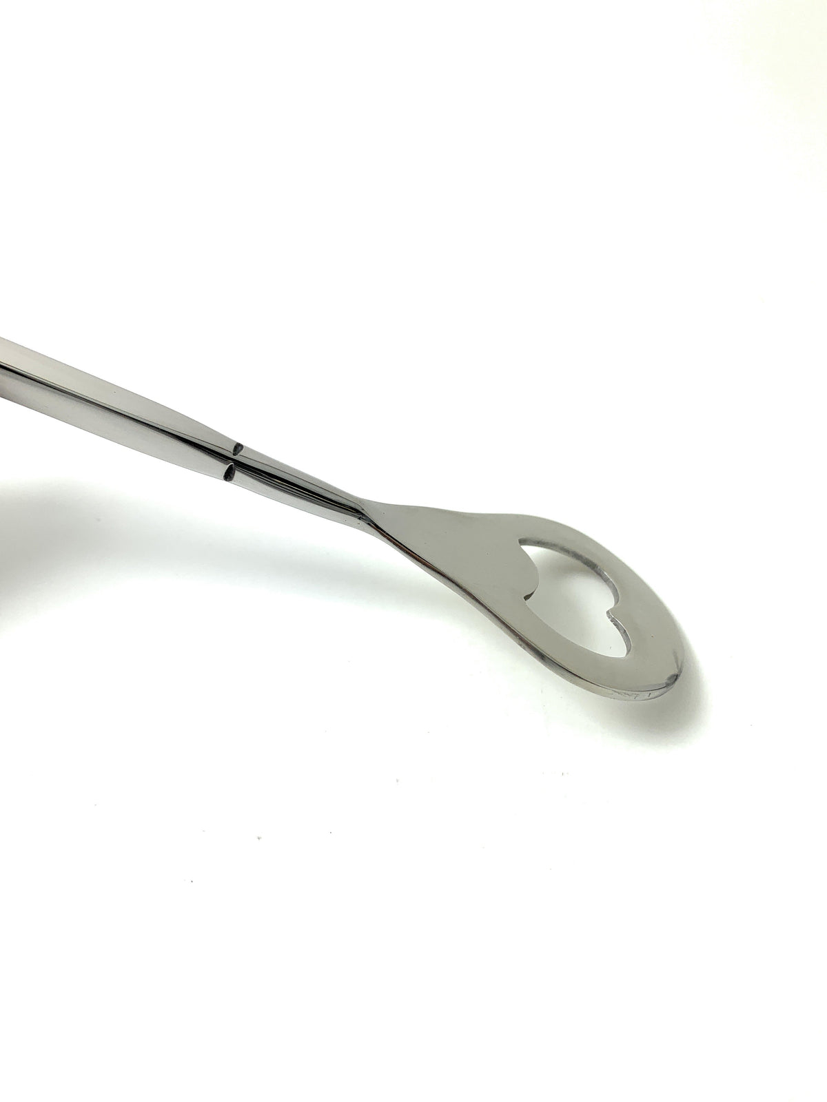 Silver bartending spoon with a heart-shaped cutout at the rounded end, shown on a white background with a polished reflective surface.