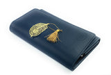 Navy blue leather cover with an embossed logo, adorned with a golden feather-shaped bookmark and tassel resting on top with white background.