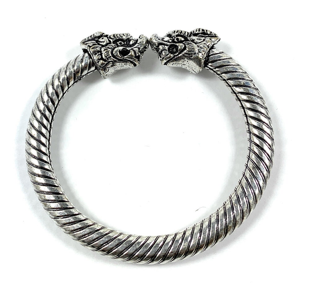 Antique Norse Viking Bracelet featuring two twisted lion heads on a bronze-tone cuff
