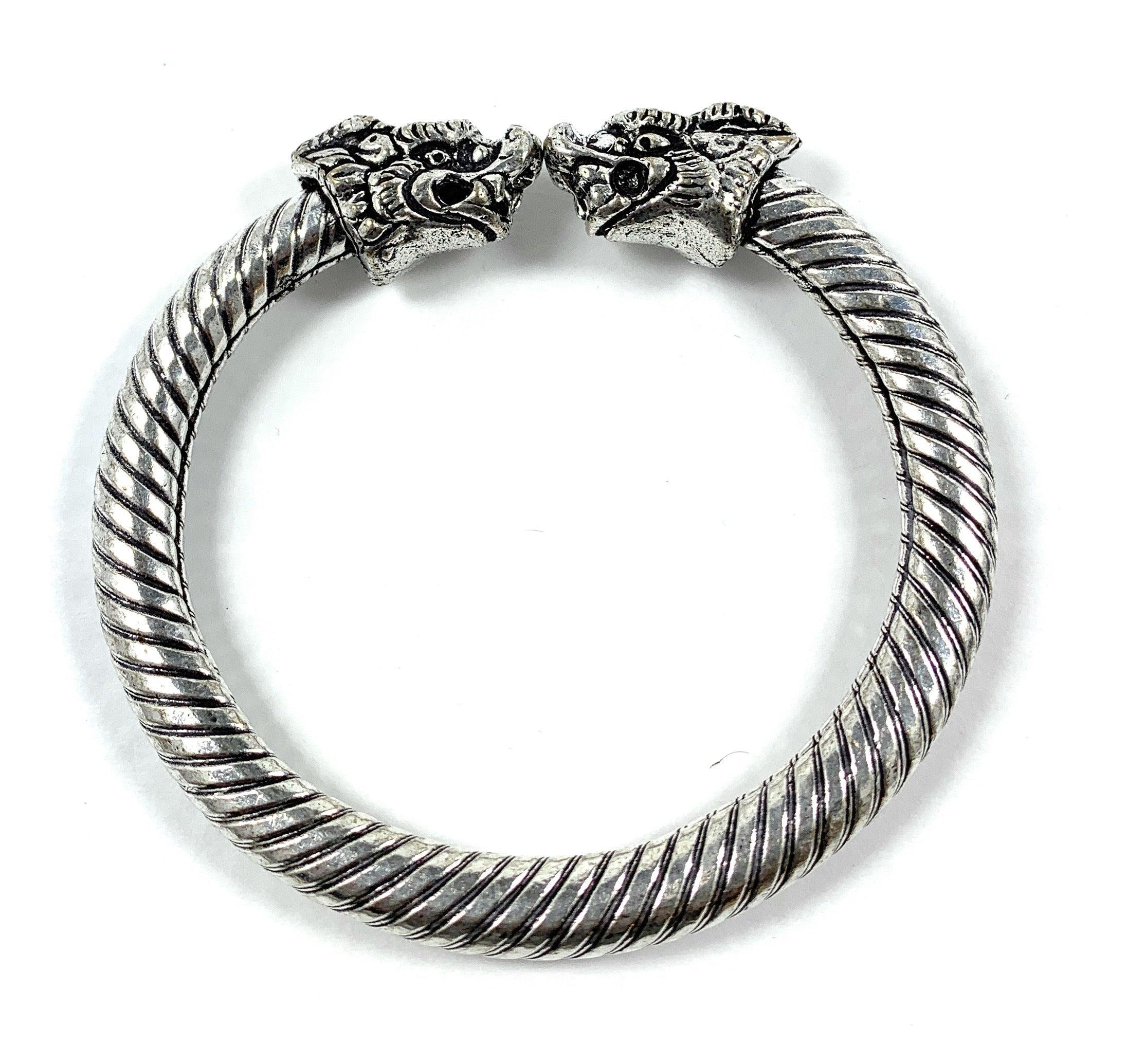 Antique Norse Viking Bracelet featuring two twisted lion heads on a bronze-tone cuff