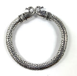 Antique Norse Bracelet with two peacock heads and snake pattern on a neutral surface