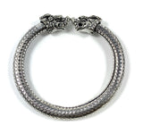 Antique Norse Bracelet with Lion Heads and Dotted Pattern lying flat with open ends facing camera
