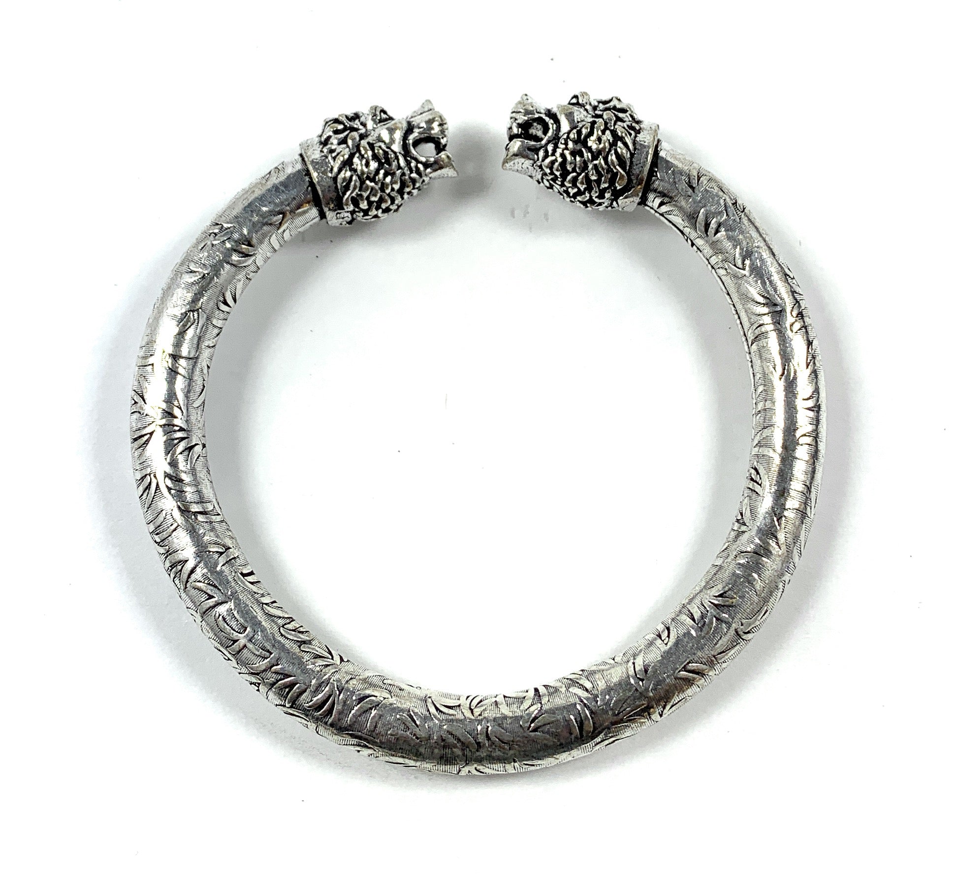 Antique Norse Lion Heads Viking Bracelet with Square Pattern on a neutral background