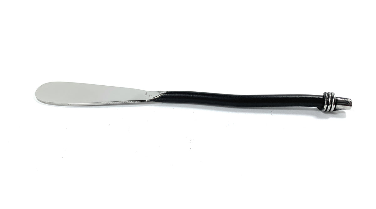 Butter spreader with a wide flat stainless steel blade and a slender black handle featuring three silver rings near the rounded end.