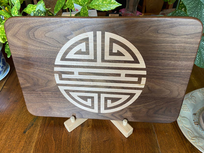 Walnut charcuterie board with Chinese Shou symbol inlay by Fitzgerald Custom Woodcraft