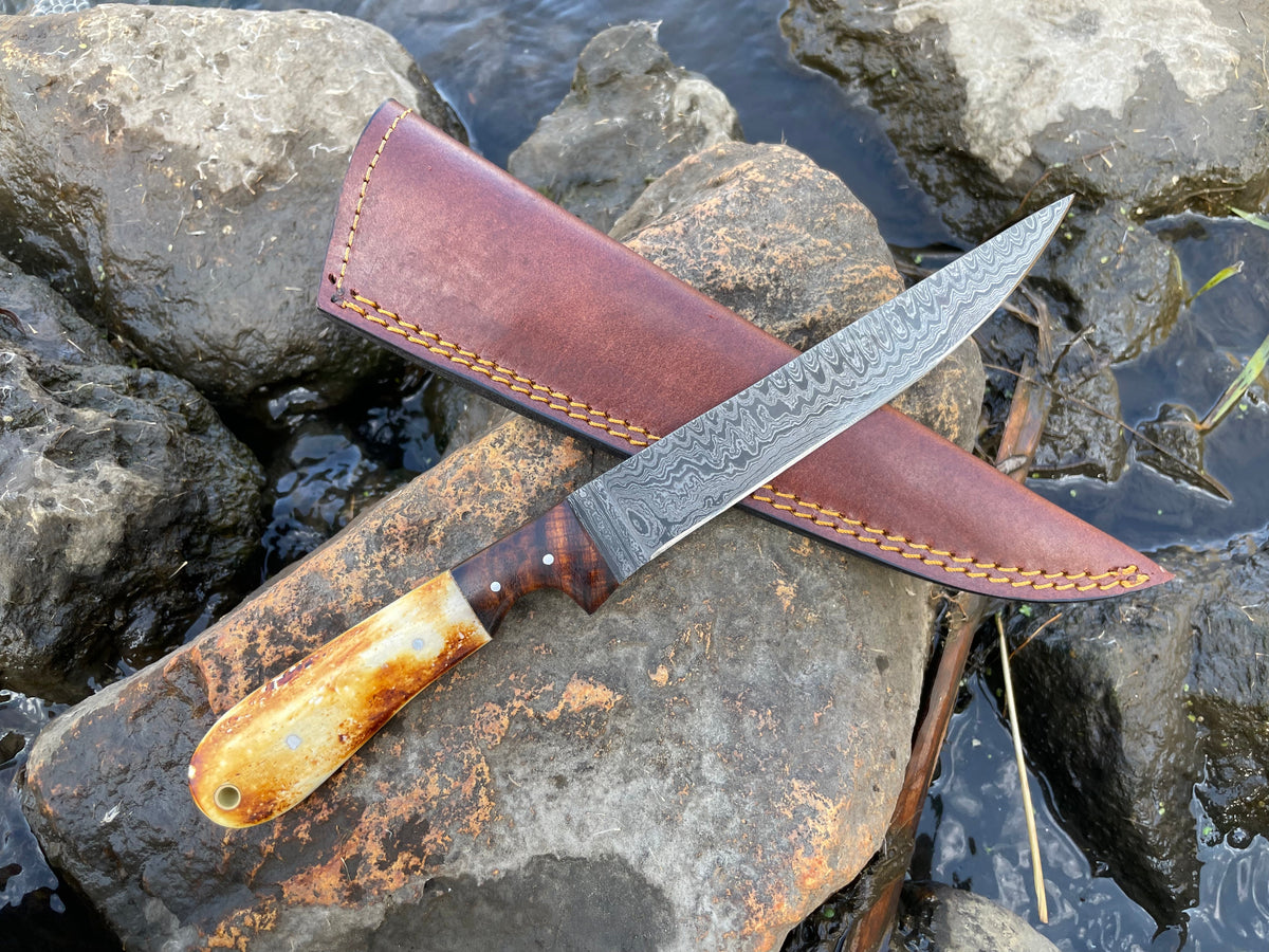 Bonning and flaying knife with High Carbon Ladder Damascus TK-034 showing the Damascus steel blade with ladder pattern and burnt bone walnut handle