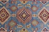 Hand-knotted Afghani Kazak wool rug with blue background featuring red, beige, and green geometric diamond motifs and stylized floral accents.