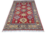 Rectangular hand-knotted Afghani Kazak wool rug with a rich red field featuring geometric medallions and a blue and cream floral border, fringed ends visible.
