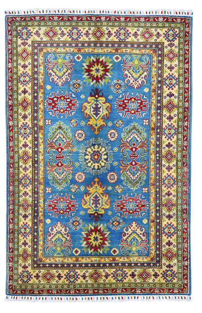 Hand-knotted Afghani Kazak wool rug featuring blue and cream traditional geometric designs, laid in a living space