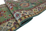 Hand-knotted Afghani Kazak wool rug in green with red, yellow, and blue geometric and floral patterns and a detailed beige border.