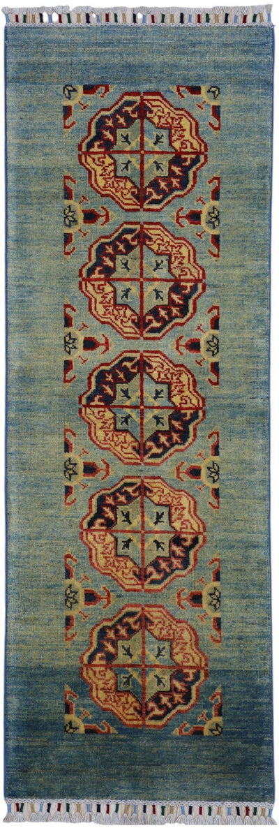 Hand-knotted Afghani Kazak wool rug in low green tones with geometric patterns displayed in natural light.