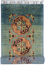 Hand-knotted Afghani Kazak wool rug with two large red and beige geometric medallions on a gradient blue to green field, featuring multicolored tassels at the top edge.