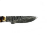 Close-up of a Damascus steel fixed blade knife showing intricate layered patterns on the blade and a handle combining walnut wood and stag horn.