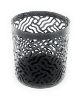 Two grey votive candle holders with laser cut patterns casting shadows