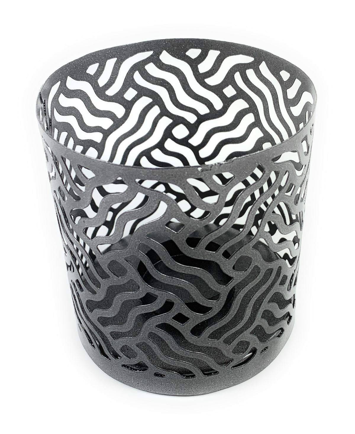 Grey metal votive candle holder with an intricate wavy cutout pattern forming abstract shapes around its cylindrical body.