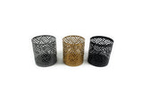 Set of three Vibhsa votive candle holders in black, grey, and golden colors arranged together