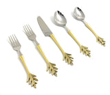 Flatware set with silver heads and golden handles featuring leaf-shaped ends, including two forks, one knife, and two spoons arranged diagonally.