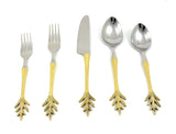 Five flatware pieces with silver tops and gold-toned handles ending in a decorative leaf-inspired design, including forks, a knife, and spoons, arranged on a white background.
