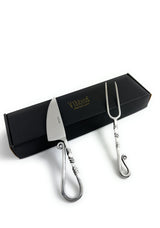 Stainless steel carving knife and fork set featuring sculpted handles with curled ends, displayed on a black box with gold branding.