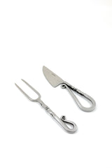 Stainless steel carving knife and two-prong fork with curled handles and decorative twisted details on a white background.