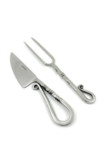 Stainless steel carving knife and two-prong fork with sculpted handles featuring curled designs and twisted details, shown on a white background.