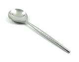 Single polished silver table spoon with a slightly hammered textured handle, shown against a white background.