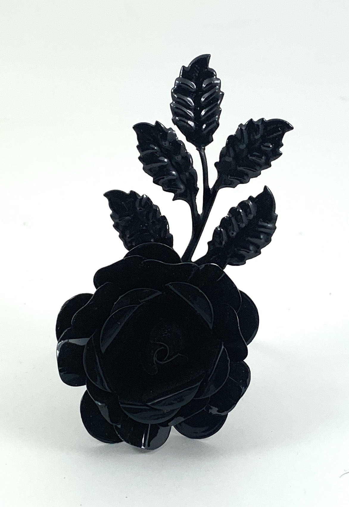 Set of four Vibhsa Black Rose napkin rings arranged on a table with white napkins