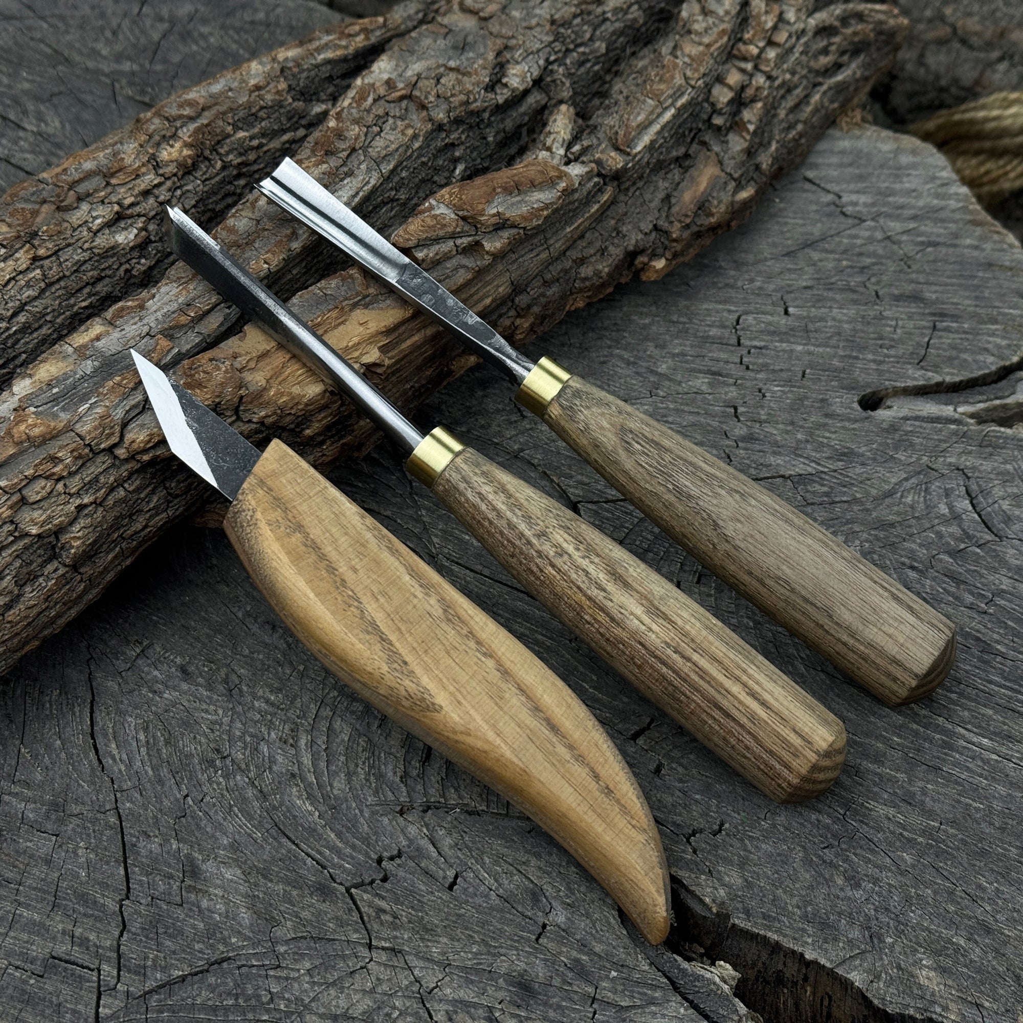 3-piece wood carving tool set with whittling knife, carving gouge, and V-parting chisel on a wooden surface