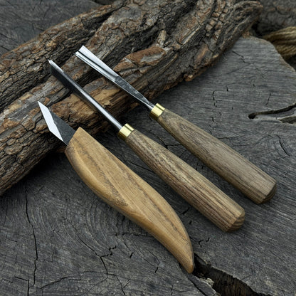3-piece wood carving tool set with whittling knife, carving gouge, and V-parting chisel on a wooden surface
