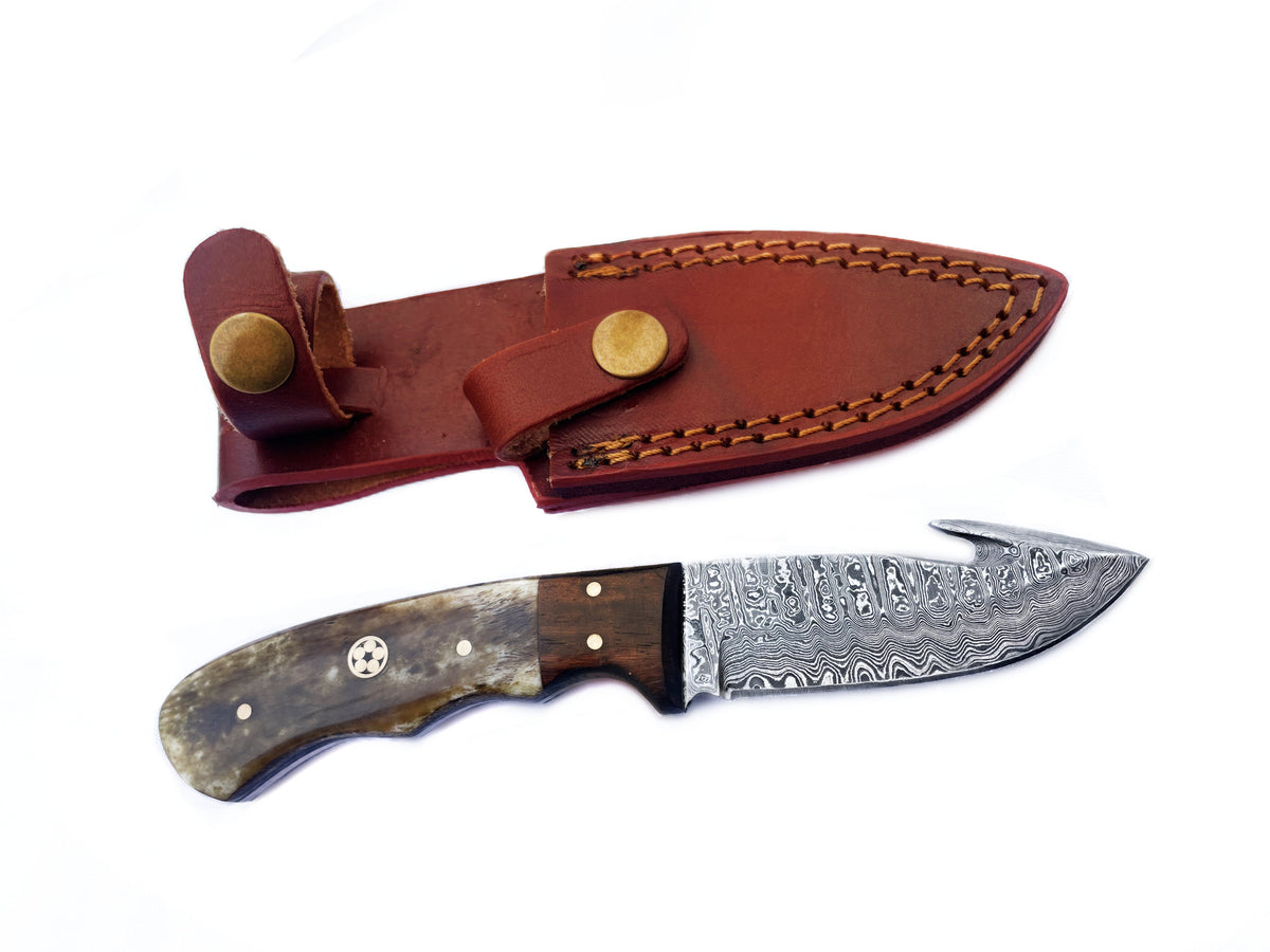 Damascus Knife Compact Utility Knife TD-176B lying on wooden surface highlighting patterned Damascus steel blade and wooden handle