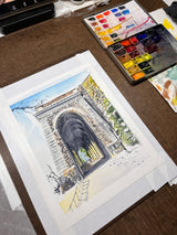 Watercolor painting of Billings Arcade in winter with detailed stone arch and shadows, surrounded by autumnal trees, displayed next to an open paint palette on a table.