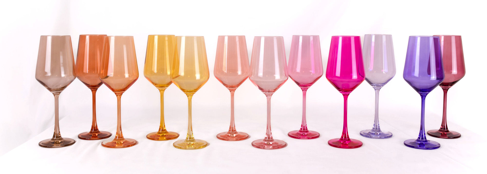 Set of 12 colorful stemmed wine glasses arranged on table