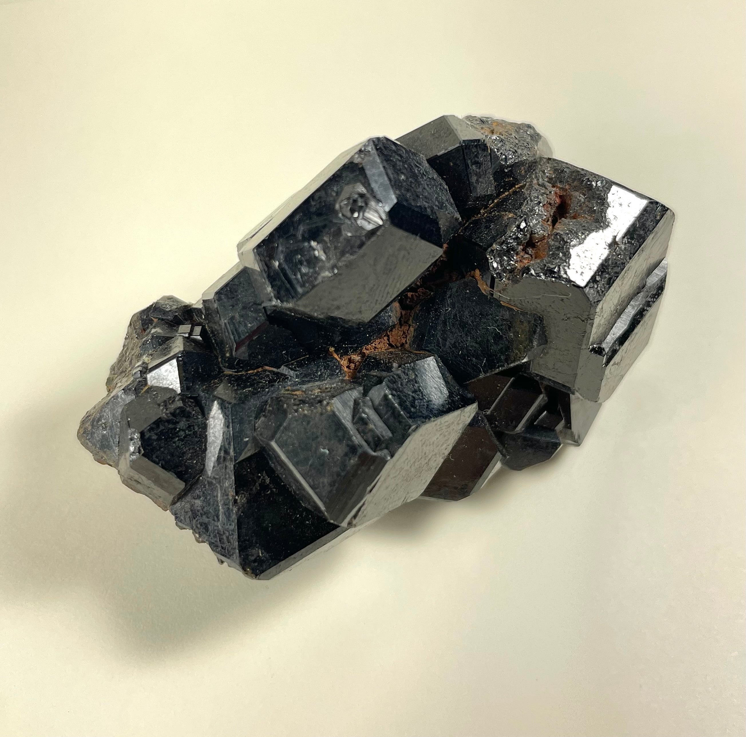 Melanite Garnet cluster mineral specimen showing dark cluster formation against light background