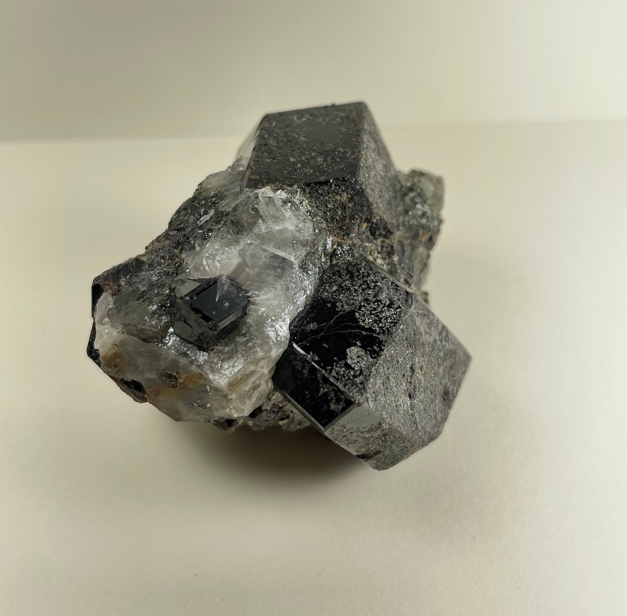 Melanite Garnet cluster with Quartz mineral specimen from California, showing dark garnet crystals and clear quartz on matrix.
