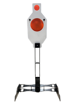 White metal IDPA Harmonic Target with two red circular areas mounted on a black signature stand with wide, angled feet for stability