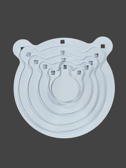 Set of five metal gongs in sizes 4, 6, 8, 10, and 12 inches arranged on a target stand outdoors.