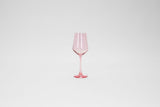 Transparent pink stemmed wine glass with a tapered bowl and a smooth, slender stem on a white background.