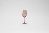 Brown sugar colored stemless wine glass with a gently tapered bowl and slender stem, shown against a plain white background.