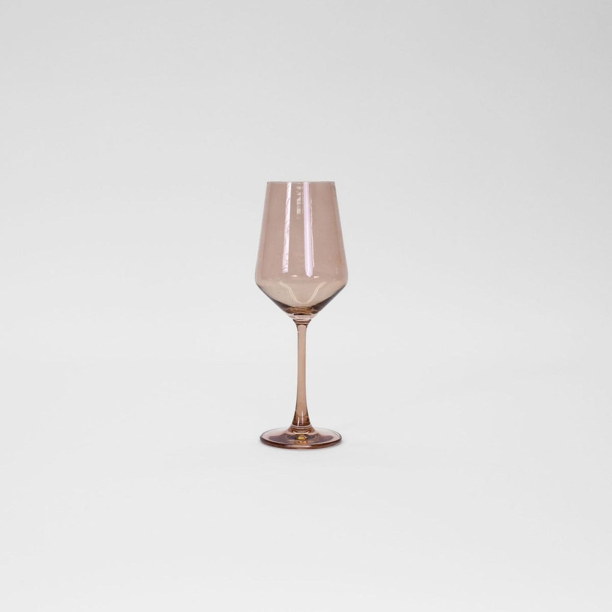 Translucent brown-tinted wine glass with a long stem and angled bowl on a plain white background.