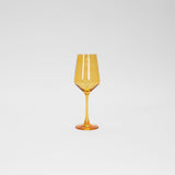 Tall wine glass with faceted bowl in translucent sunshine yellow glass and a slender, smooth stem and base, set against a plain white background.