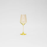 Tall wine glass with a delicate lemon-yellow tint on the bowl, stem, and base against a plain white background.