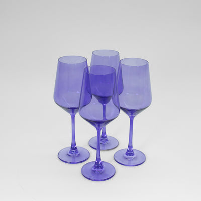 Veri Peri Purple wine glass with a vibrant blue-purple hue on a neutral background