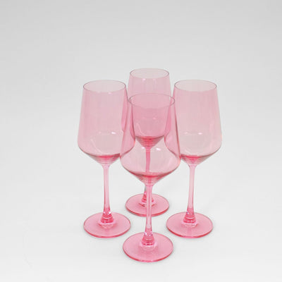 Bubblegum Pink colored wine glass from GlassHauseCo set against a neutral background