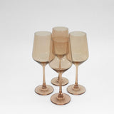 Brown Sugar colored wine glass with golden amber ombré effect shown amongst natural decor