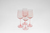 Set of four pink-tinted stemmed wine glasses with a translucent finish displayed on a white background.