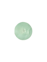 Smooth, rounded sea glass ornament in translucent pale green with natural surface texture and subtle variations in opacity, shown against a white background.